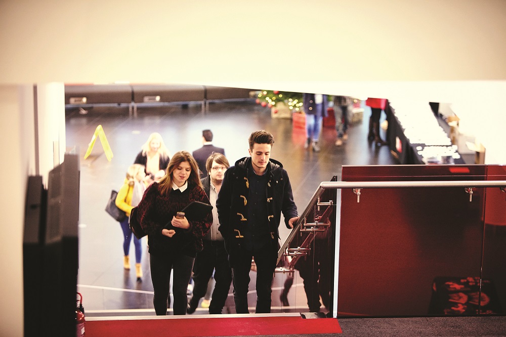 Business school postgraduates climbing stairs on the MediaCity campus