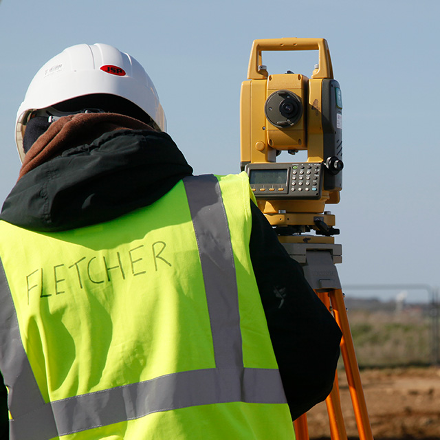 Civil engineering student completing a surveying task