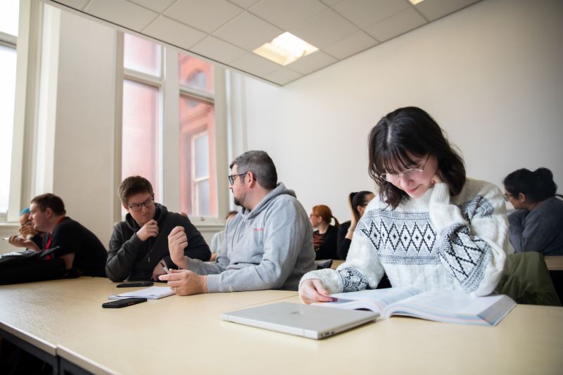 A group of students studying in a seminar room