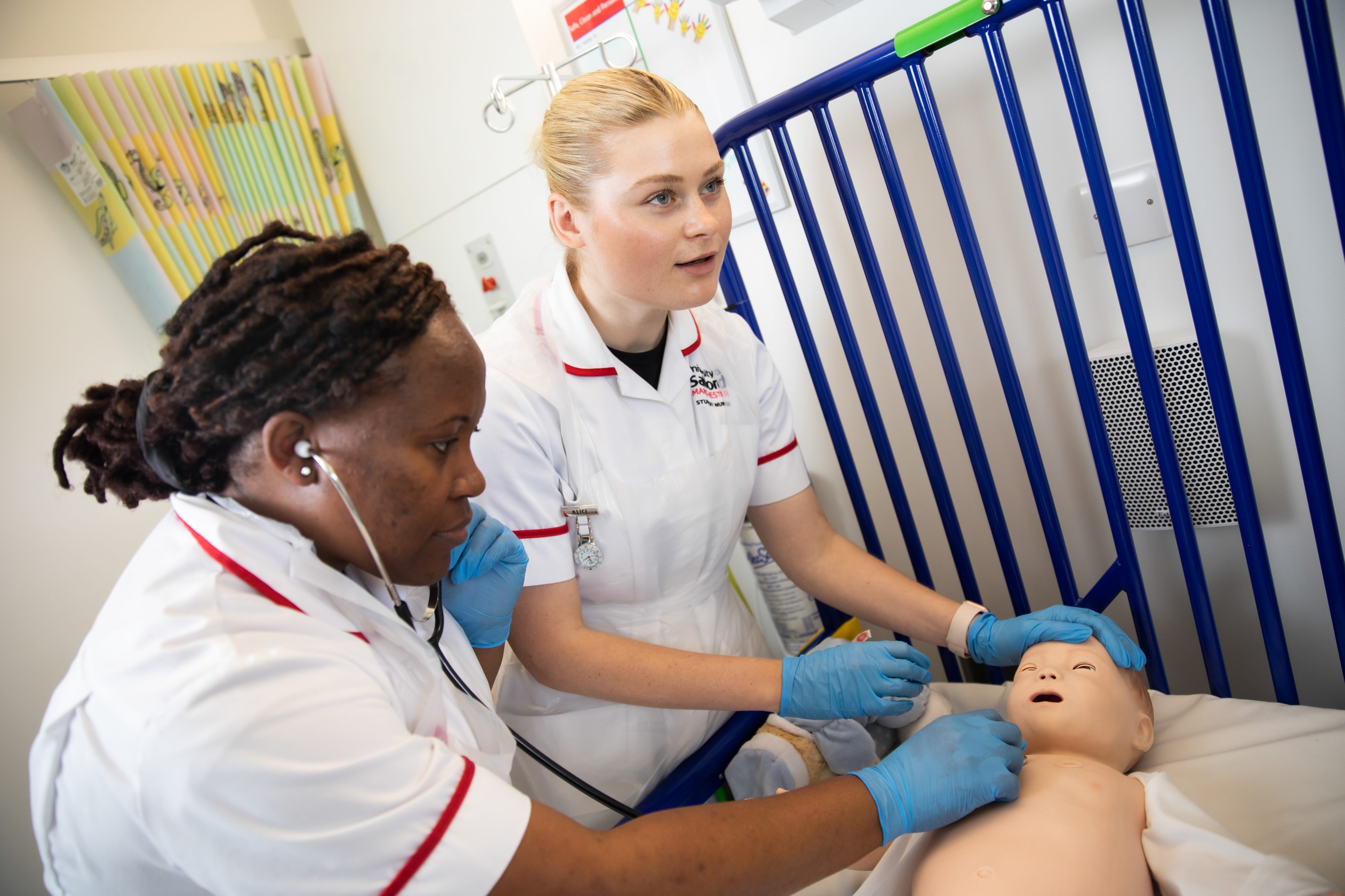 International nursing students practicing on a child mannikin in the simulation suites