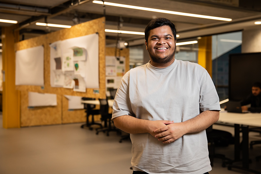Student smiling inside the University of Salford's Architecture studios