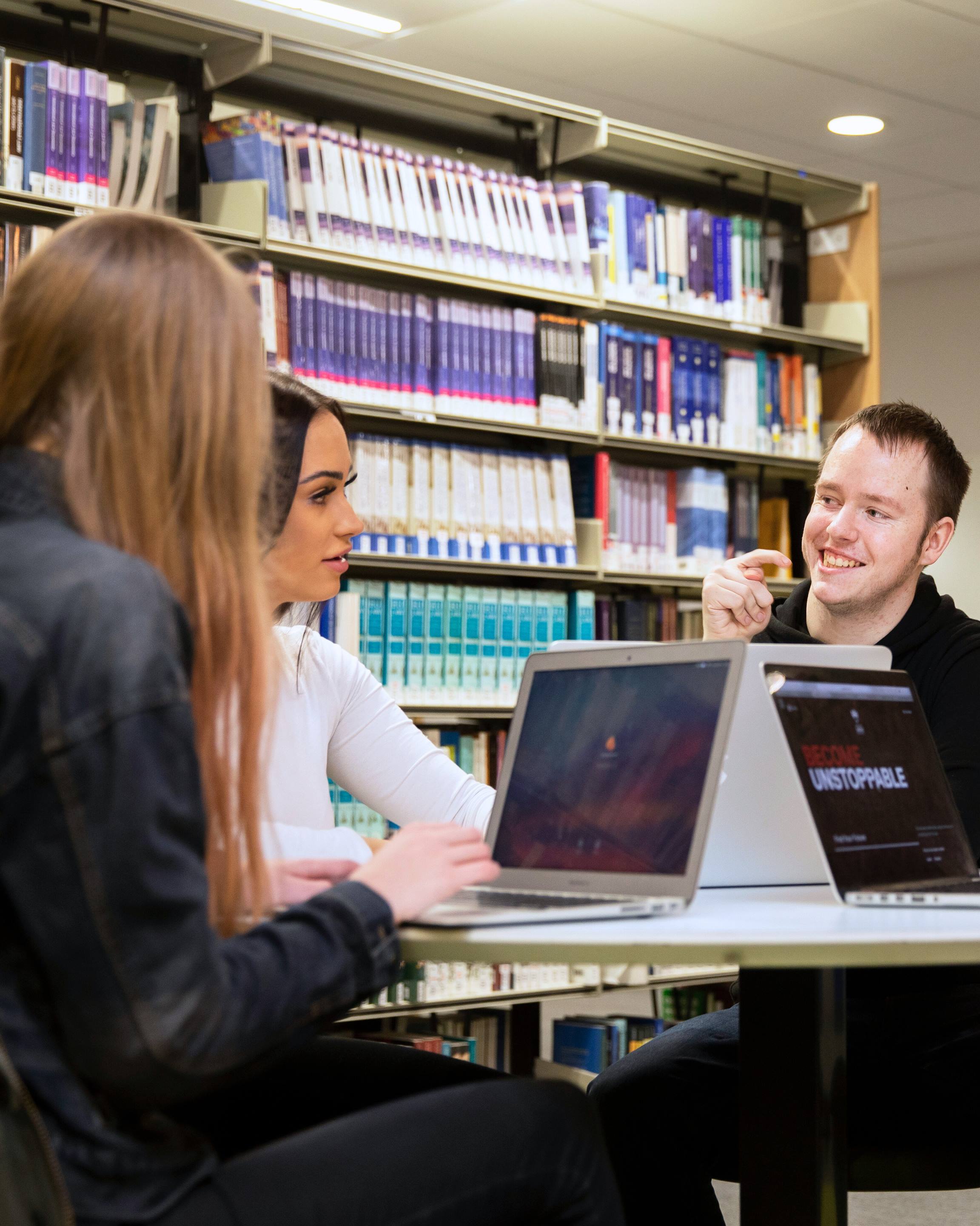 Students around a table in Clifford Whitworth Library, University of Salford