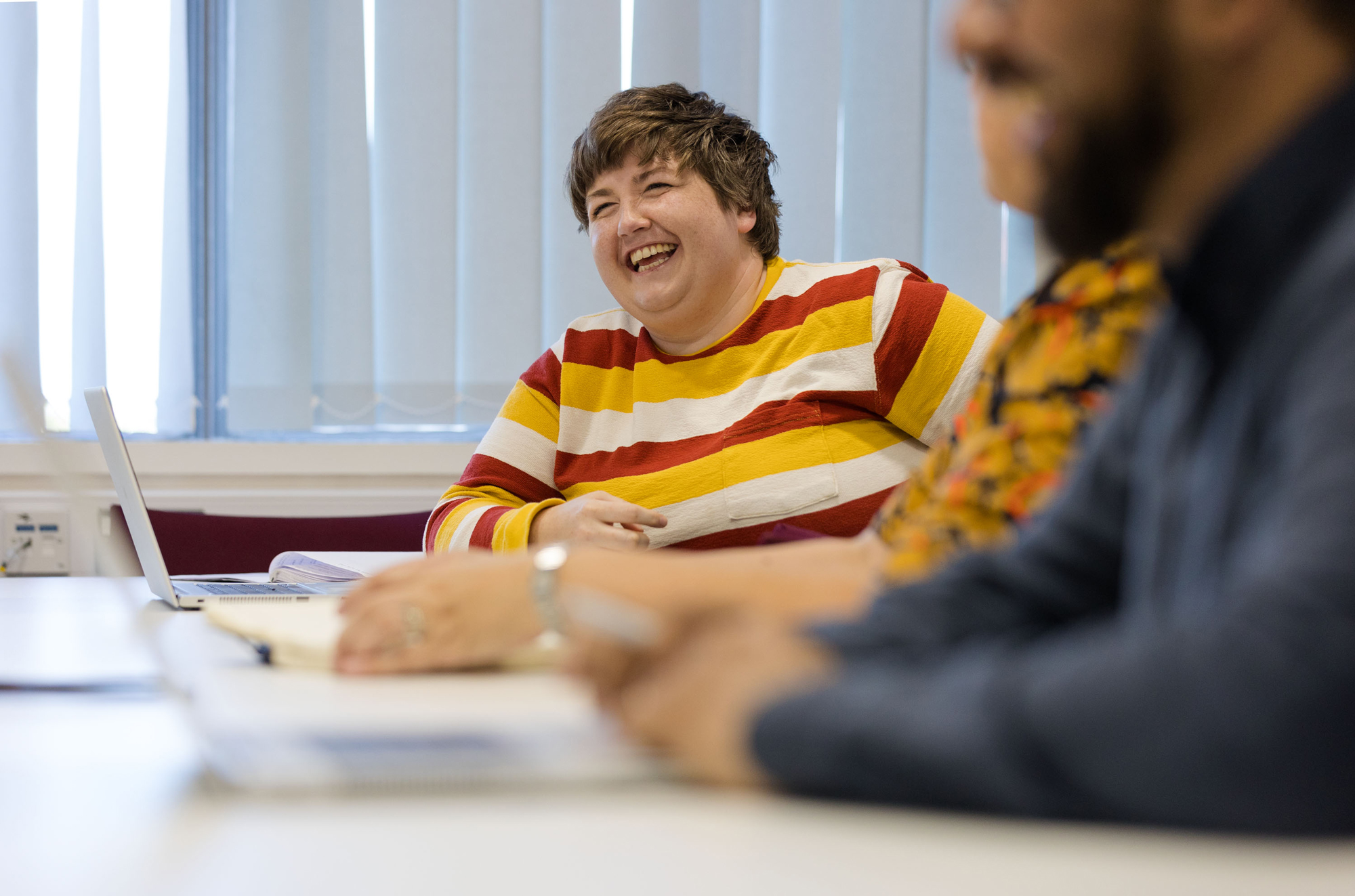 Colleague smiling in a meeting