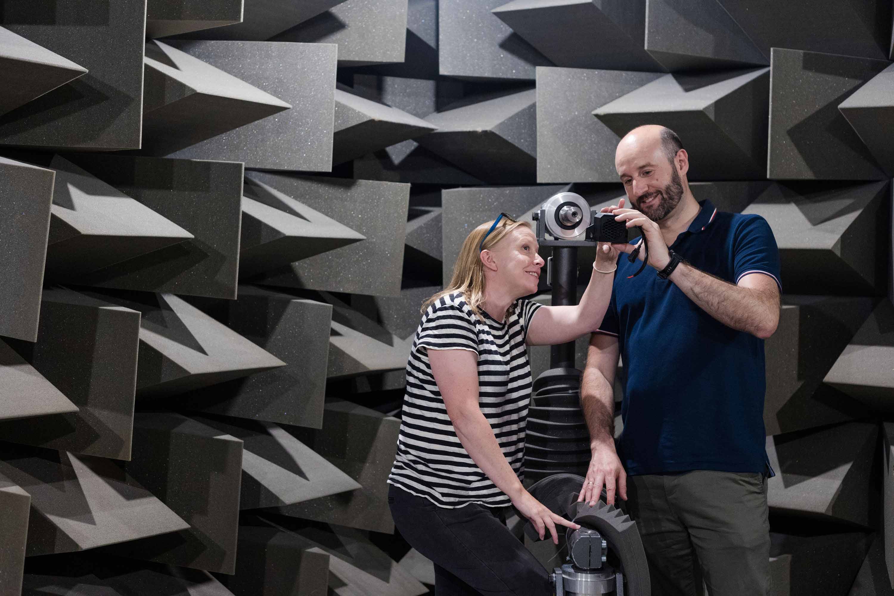 Colleagues operating equipment in the Acoustics Lab at the University of Salford