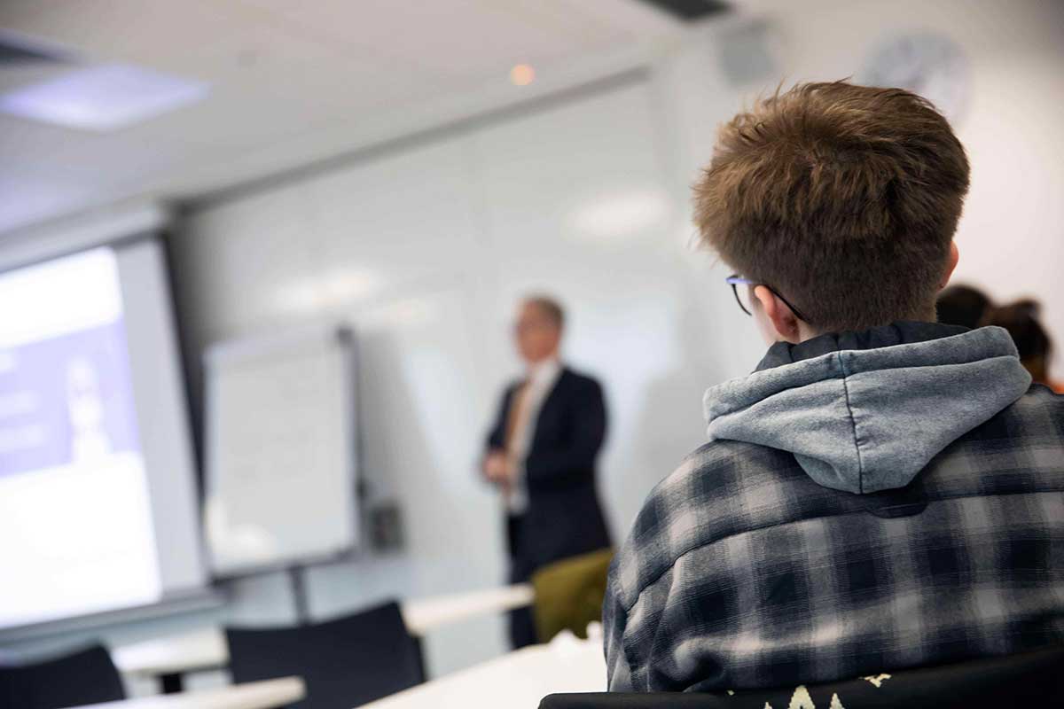 A student watches an employer presentation