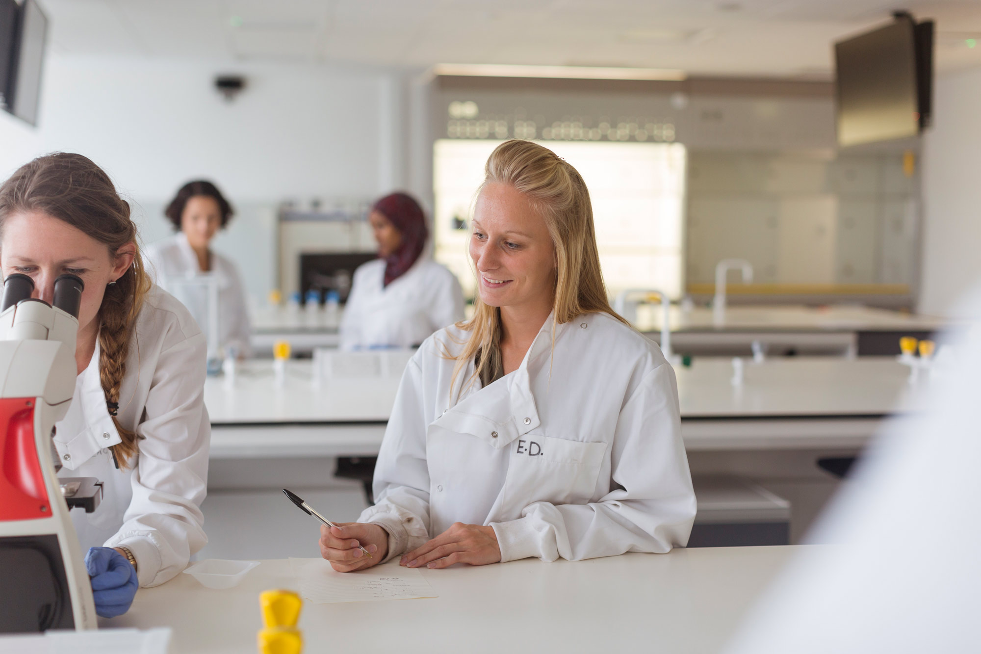 Biochemistry Students Using Microscope