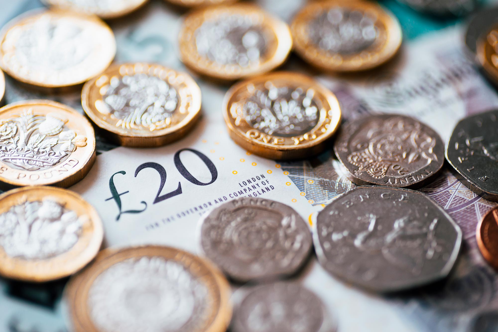 English currency, various coins surrounding paper notes