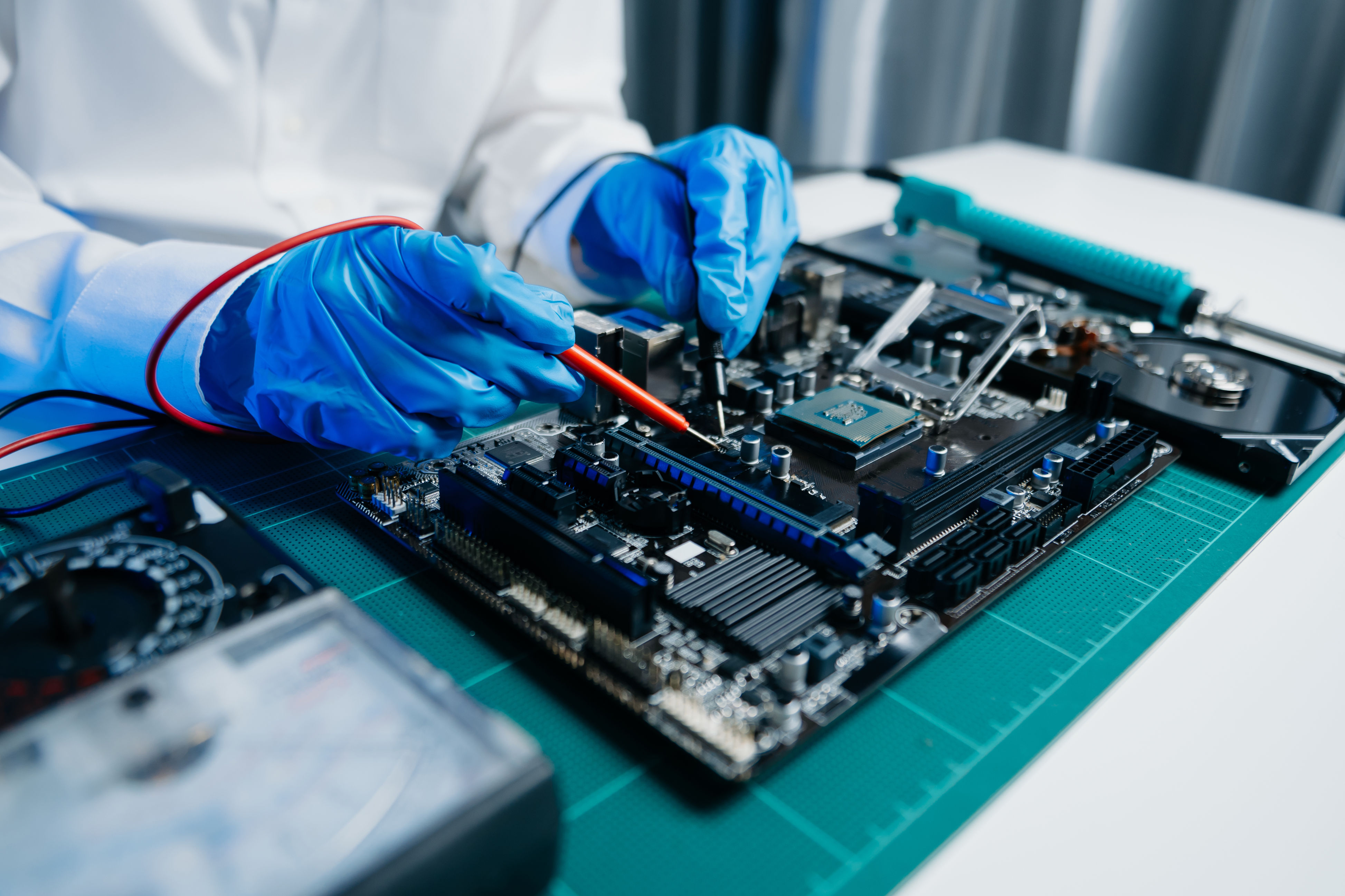 Student wearing gloves using an electric board