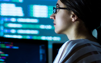 Woman working in front of a computer screen