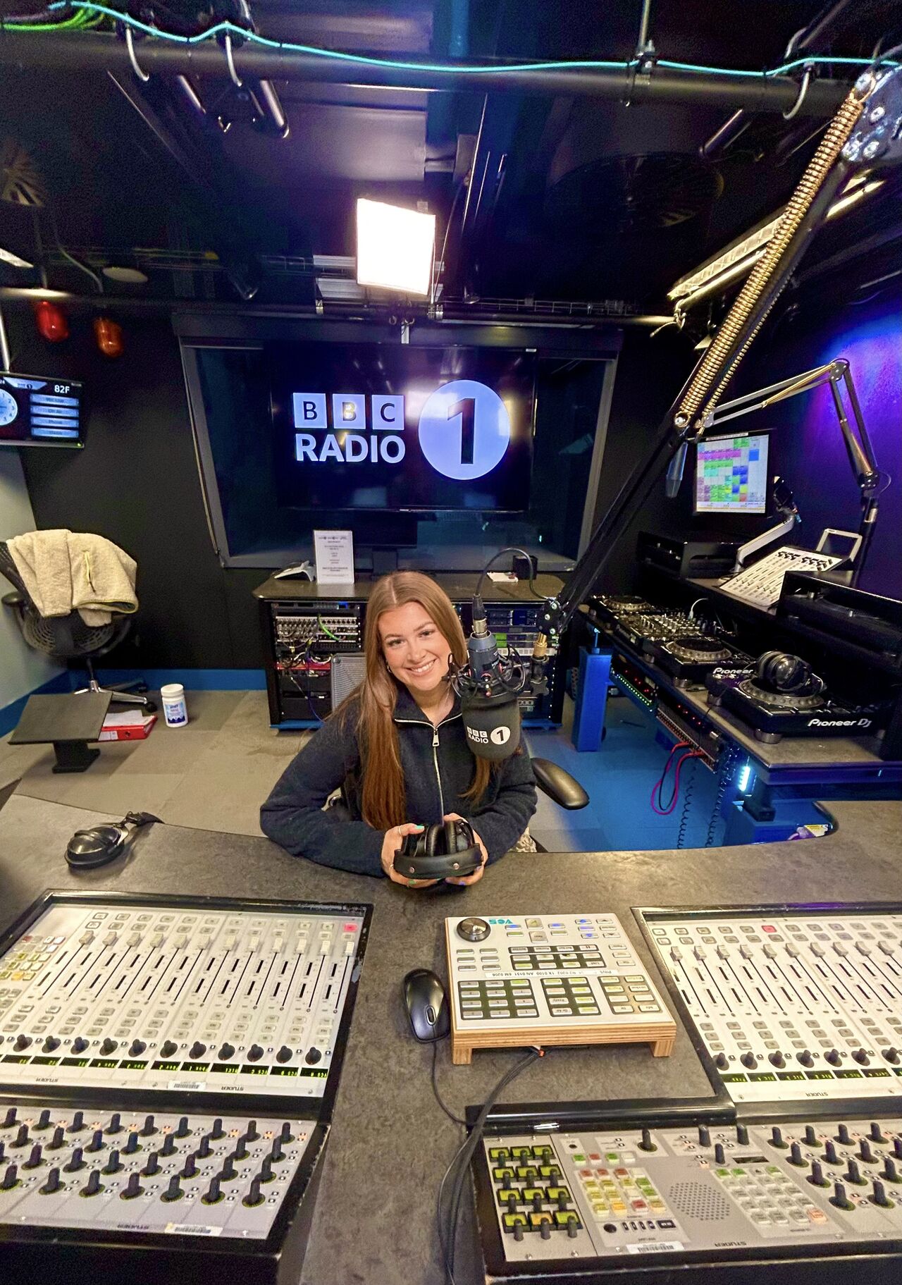 Cushla Rice sits by the decks in the BBC Radio 1 recording studio