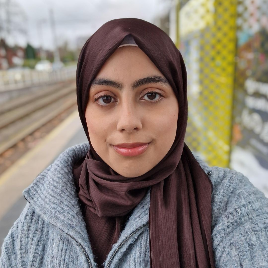 An image of Fatima Khan standing at a tram stop