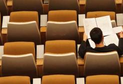 A person works in a lecture theatre