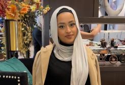 A woman in a hijab sat in a restaurant. 