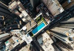 Looking downwards on city sky scrapers and swimming pool