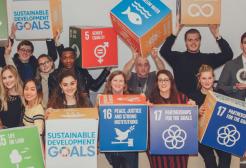 Students and staff holding Sustainable Development Goals cubes