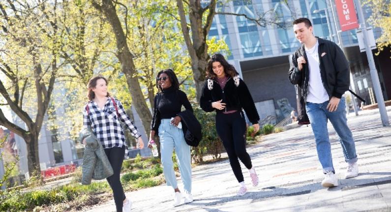 A group of students walking across campus