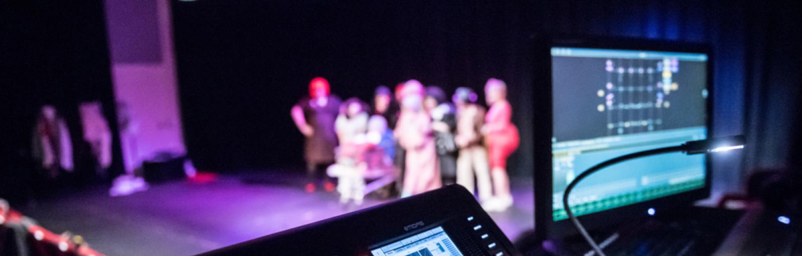 Cameras and recording equipment filming students on stage