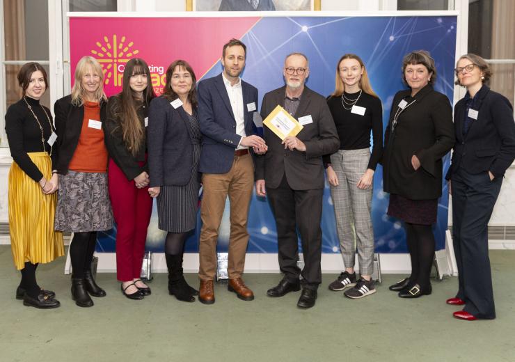 Dr David Frayne being presented with the Celebrating Impact Prize 2024 with other university fellows