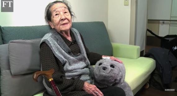 Elderly person with an AI robot teddy