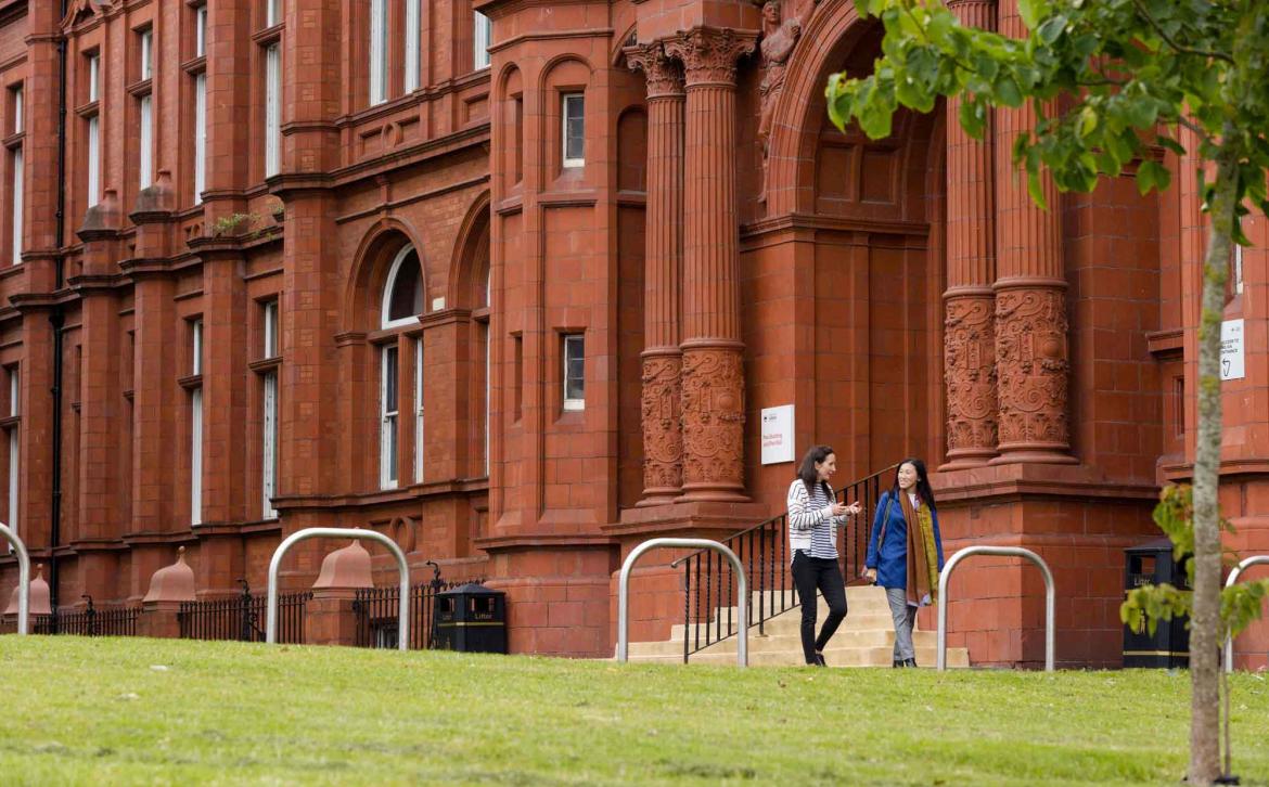 Colleagues walking across Peel Park campus